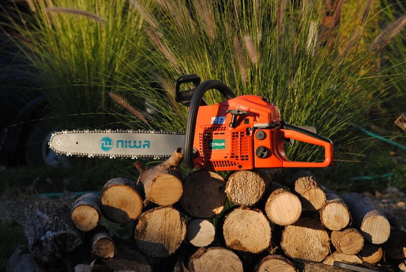 Professional chainsaw on firewood